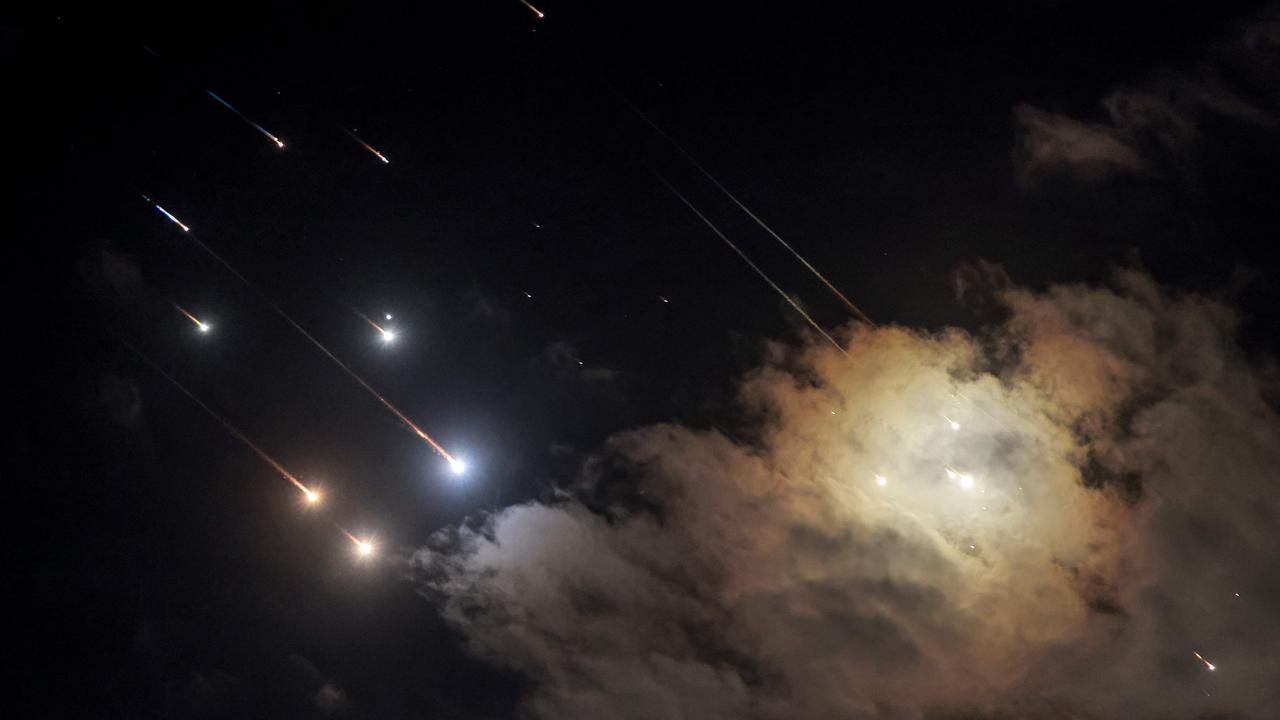 This picture shows projectiles being intercepted by Israel near the northern city of Baqa al-Gharbiya on October 1, 2024. (Photo by Menahem Kahana / AFP)