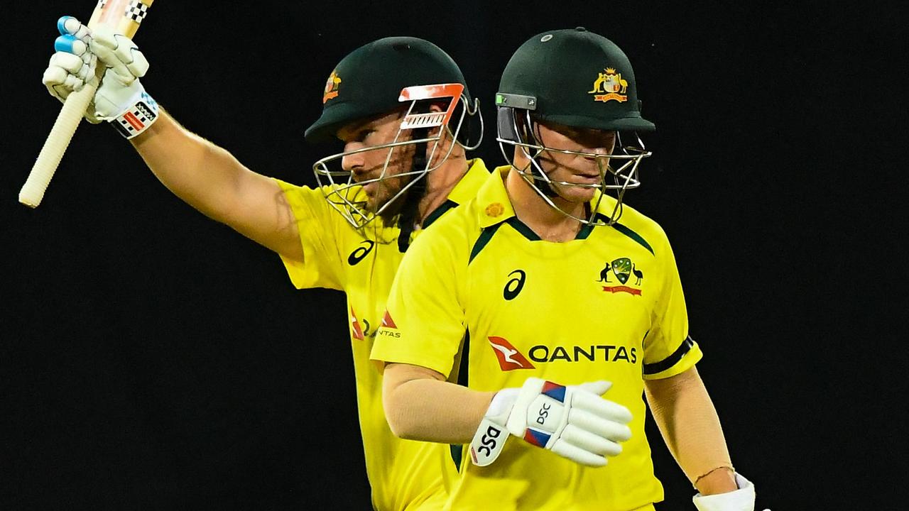 Australia's captain Aaron Finch (L) celebrates after scoring a half-century (50 runs) as his teammate David Warner watches during the first Twenty20 international cricket match between Sri Lanka and Australia at the R. Premadasa International Cricket Stadium in Colombo on June 7, 2022. (Photo by ISHARA S. KODIKARA / AFP)