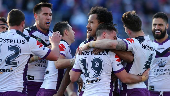 NEWCASTLE, AUSTRALIA — AUGUST 19: Storm Players celebrate a try during the round 24 NRL match between the Newcastle Knights and the Melbourne Storm at McDonald Jones Stadium on August 19, 2017 in Newcastle, Australia. (Photo by Ashley Feder/Getty Images)