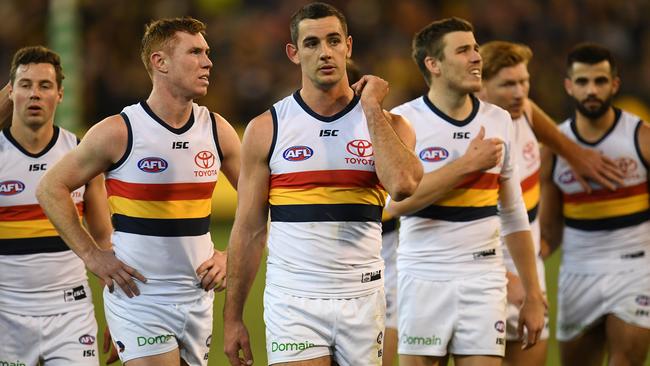 Taylor Walker of the Crows (third from left) leads his players from the field after the Round 16 AFL match between the Richmond Tigers and the Adelaide Crows. Picture: AAP Image/Julian Smith