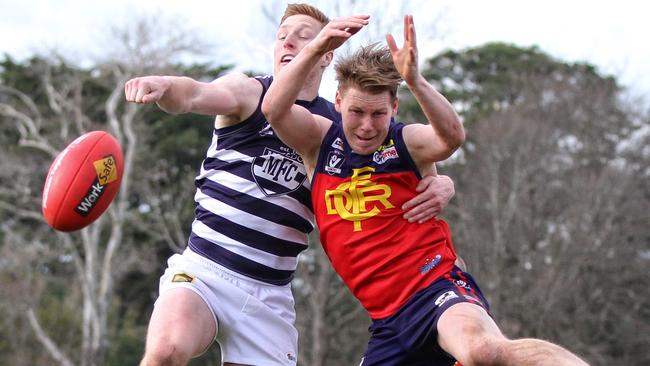 Matthew Dick punches the ball away from Josh Wallace. Picture: Aaron Cook