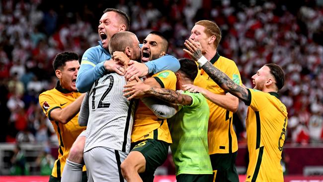 Andrew Redmayne is mobbed after saving the decisive penalty.