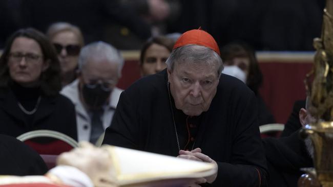 George Pell prays near the body of the late Pope Emeritus Benedict XVI. Picture: EPA.