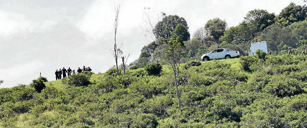 REMOTE SITE: Specially trained police consider their next move, as investigation and recovery efforts continue into the fatal plane crash near Woolooga on Saturday which claimed the life of Yandina pilot Rob Pavan. Picture: Patrick Woods