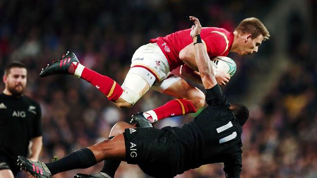 Liam Williams of Wales clashes with Waisake Naholo of New Zealand.