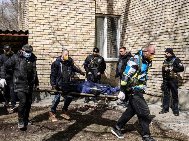 A body is carried at a school in Bucha, northwest of the Ukrainian capital Kyiv. Picture: AFP