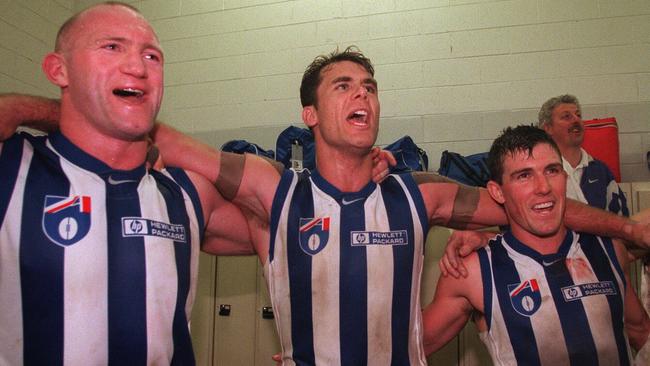 Carey celebrates a win with his North Melbourne teammates in 1998.