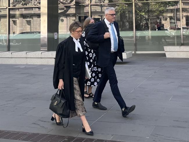 Ewen Addison with his lawyer Kate Ballard before he was taken into custody. Picture: Laura Placella