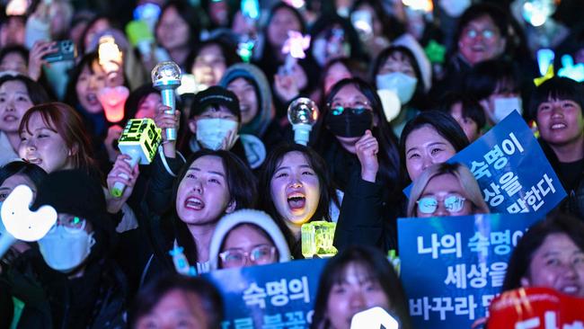 Protesters calling for the ouster of South Korea President Yoon Suk Yeol react after the result of the second martial law impeachment vote outside the National Assembly in Seoul on December 14, 2024. Picture: AFP.