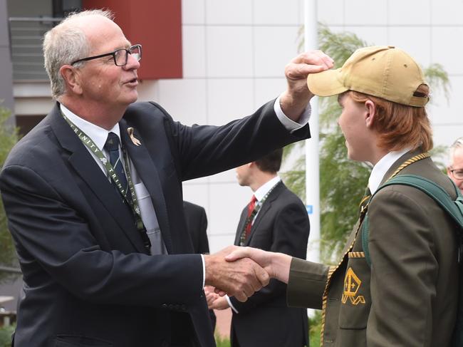 A quick hair check. Deputy Headmaster Rohan Brown returns to Trinity Grammar and is greet by students and parents at the start of term. Picture: Tony Gough