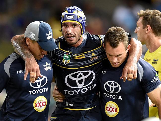 Injured Cowboys captain Johnathan Thurston is helped from the field.