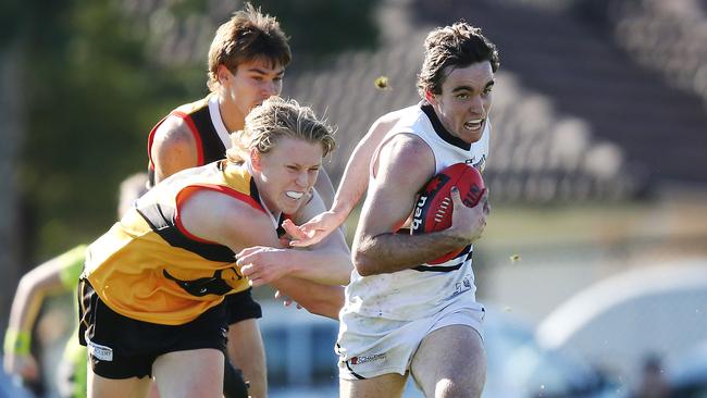 Sam Philp bursts away from a Dandenong Stingrays tackler.