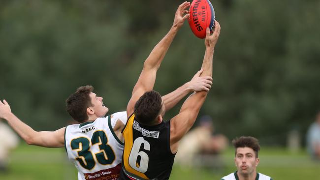 Paul Stenicke (Northcote Park) is outmarked by Josh Gribben of Heidelberg. Picture: Stuart Milligan