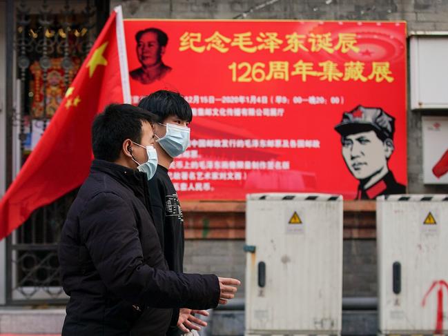 Chinese people wear protective masks on commercial street in Beijing. Picture: Getty Images