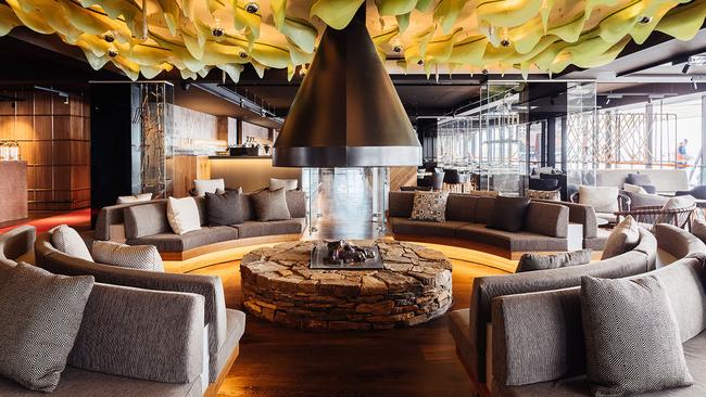 The circular fireplace in the Lounge is sculpted from river stones. Picture: Adam Gibson