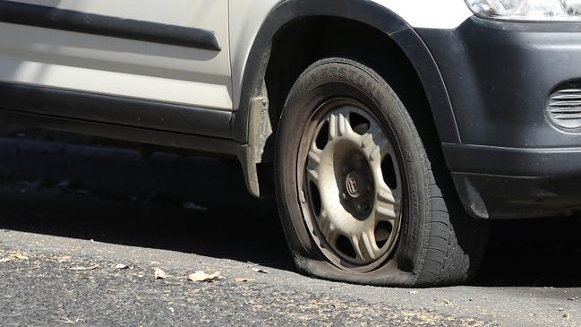 A small truck, car and police vehicle have had their tyres slashed on the Monash Freeway after a botched arrest. Picture: Zak Simmonds