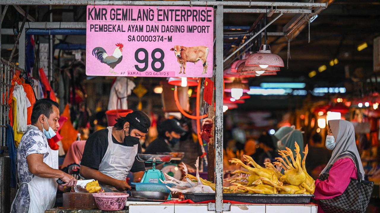 A customer waits to buy chicken meat at a wet market September 1. Picture: Mohd Rasfan / AFP