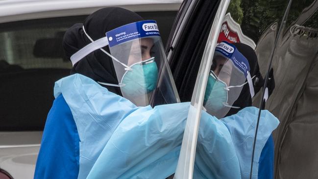 Testing at the Auburn Community Health Care Centre drive-through clinic. Picture: Monique Harmer