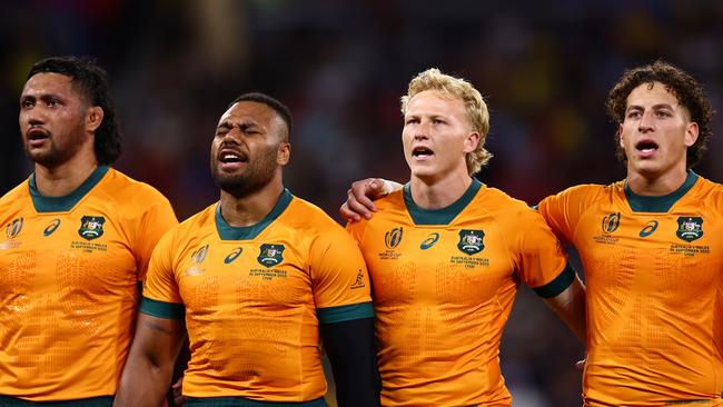 Carter Gordon (second right) and fellow union defector Mark Nawaqanitawase (R) sing the national anthem prior to kickoff of a match at the 2023 Rugby World Cup. Picture: Getty Images