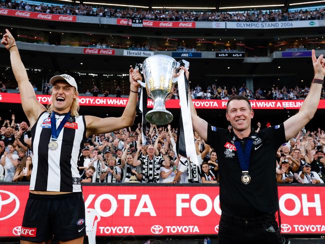 MELBOURNE, AUSTRALIA - SEPTEMBER 30: Darcy Moore of the Magpies and Craig McRae, Senior Coach of the Magpies celebrate with the premiership cup during the 2023 AFL Grand Final match between the Collingwood Magpies and the Brisbane Lions at the Melbourne Cricket Ground on September 30, 2023 in Melbourne, Australia. (Photo by Dylan Burns/AFL Photos via Getty Images)