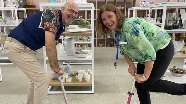 St Vincent de Paul Society Far North Queensland executive officer David Monaghan and store manager Toni Robson scoot through their new store in Cairns. Picture: Andreas Nicola