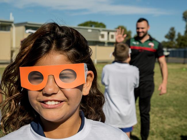 Bourke Public School student Shanorah tries out cataract glasses during a Souths Cares rugby league clinic in support of The Fred Hollows Foundation and the Outback Eye Service.