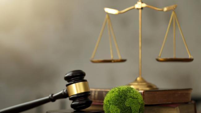 International Law and Environment Law. Green World and gavel with scales of justice and books. law for global economic regulation aligned with the principles of sustainable environmental conservation.