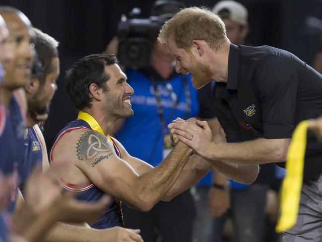 Britain's Prince Harry, the Duke of Sussex presents a medal during the medal presentation following the Wheelchair Basketball Final at the Invictus Games in Sydney. Picture: AAP