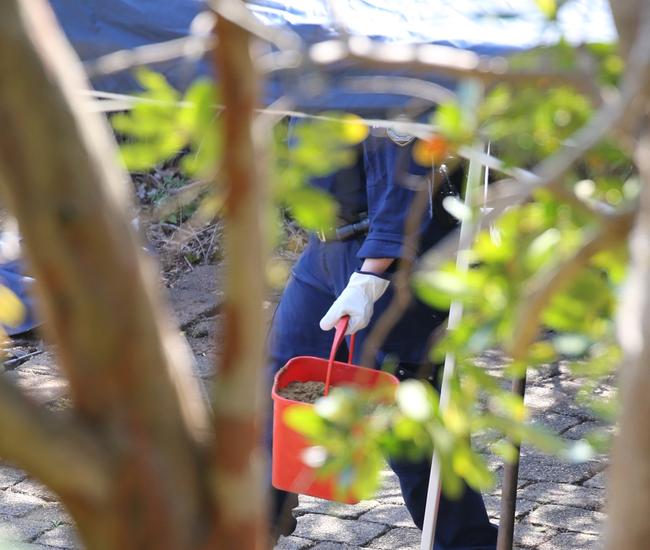 An officer who is part of the excavation at 2 Gilwinga Drive, Bayview. Picture John Grainger