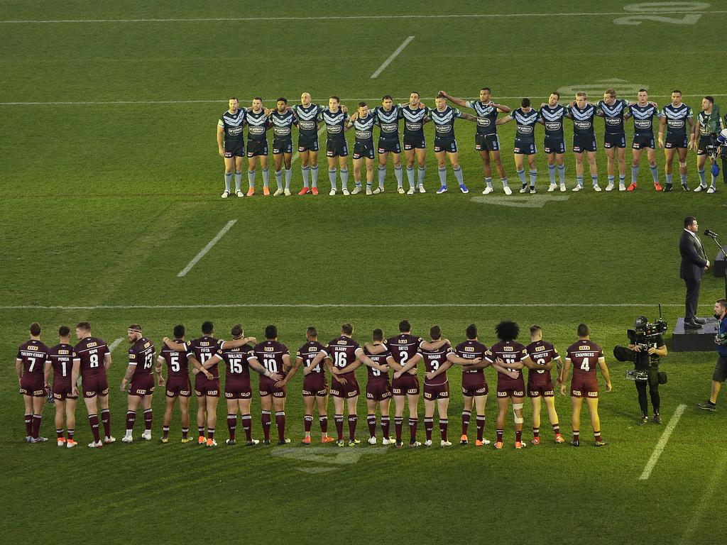 The teams line up as  the Australian national anthem is played during game two of the 2019 State of Origin series. (Photo by Will Russell/Getty Images)