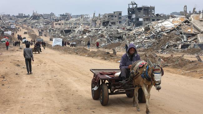 A man rides a cart past the rubble of destroyed buildings at Saftawi street in Jabalia, in the northern Gaza Strip. Picture: AFP.