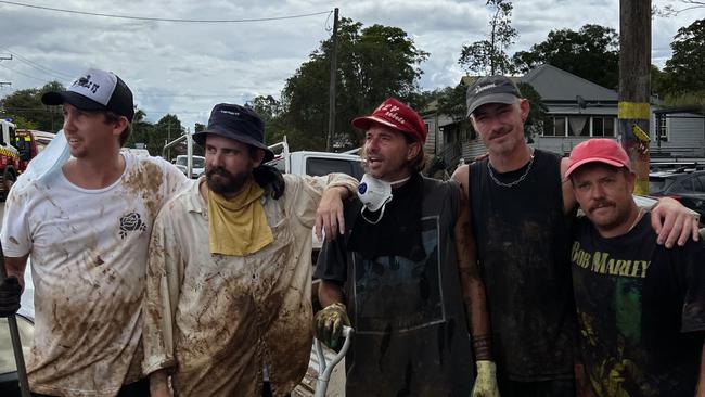 Getting their hands dirty during the flood clean-up are (from left) Jack Neate, Matty Bouris, Adam Grygoruk, Nathan Landers and Troy Freyee.