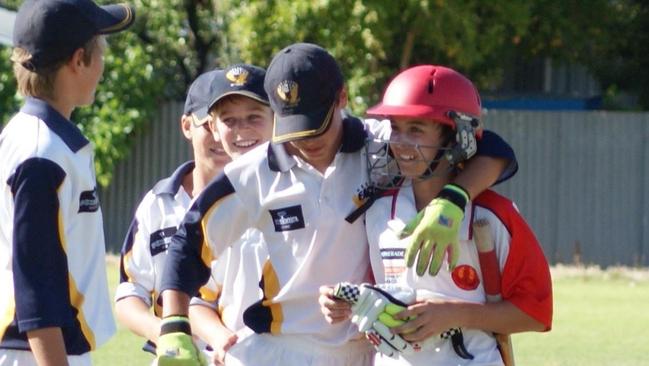 Connor Rozee, in the red helmet, playing cricket for East Torrens.