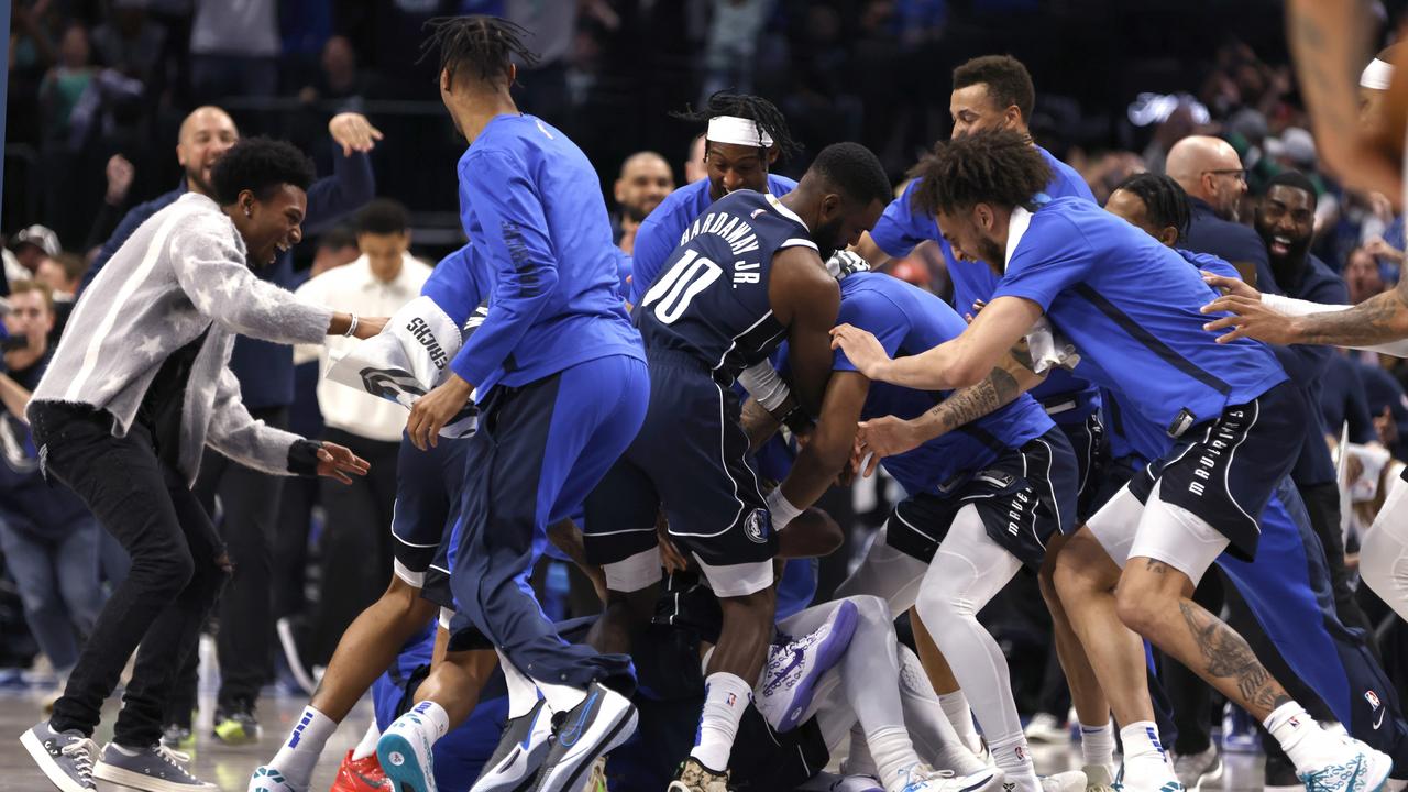 The Mavericks celebrate after Kyrie Irving made a last-second game winning shot. (Photo by Ron Jenkins/Getty Images)