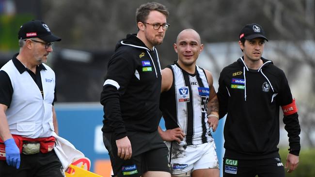 Alex Woodward is distraught after suffering his fifth ACL injury, during Saturday’s VFL match between Collingwood and Box Hill Hawks. Picture: AAP