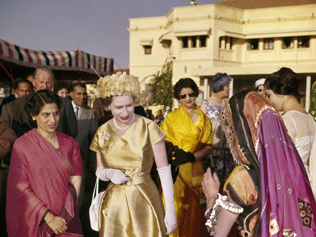 Queen Elizabeth II admiring Indian fashion during the Royal Tour of India, circa January 1961. Picture: Getty Images