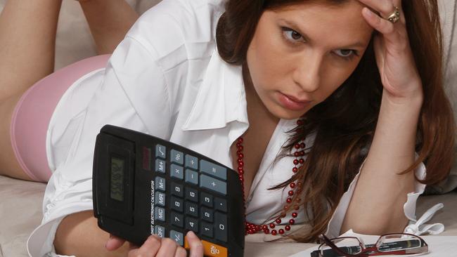 Tax - Woman holding a calculator worrying over her tax