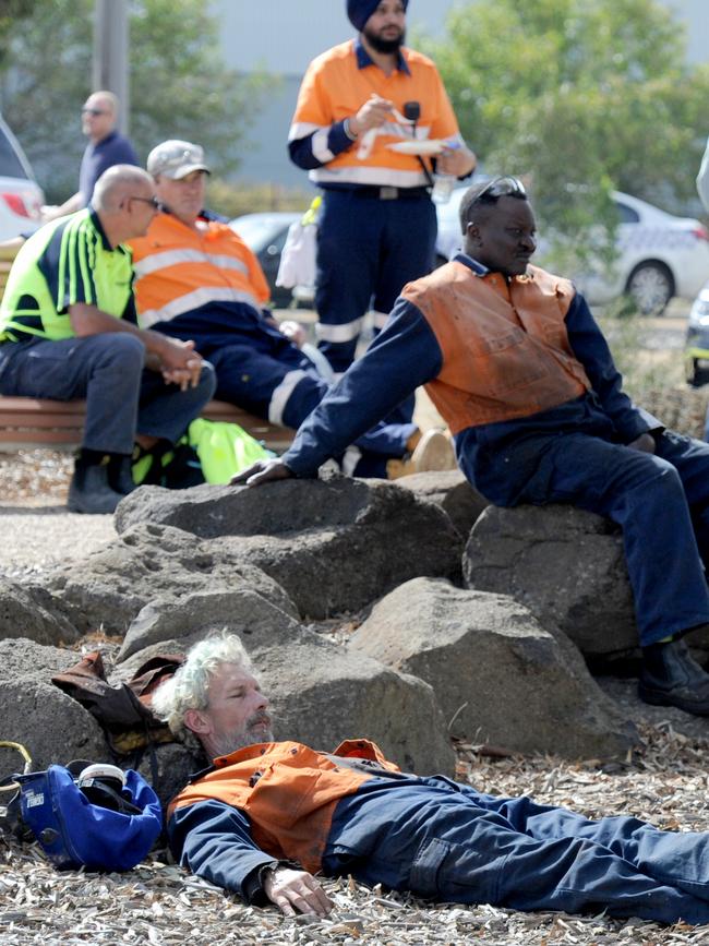 Workers assemble after escaping the Campbellfield fire. Picture: Andrew Henshaw