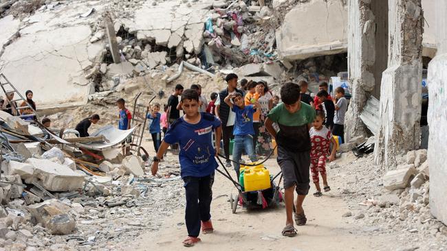 Displaced Palestinian ferry water from a distribution point in the Shujaiya neighbourhood of Gaza City this week. Picture: AFP