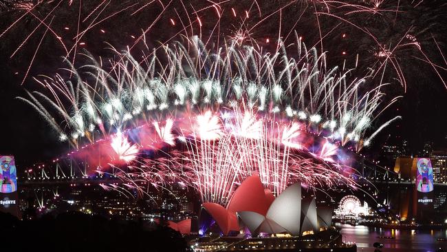 New Year's Eve 2018 and the midnight fireworks display over the Sydney Opera House and Sydney Harbour Bridge from a rooftop in Potts Point. Pic: Toby Zerna