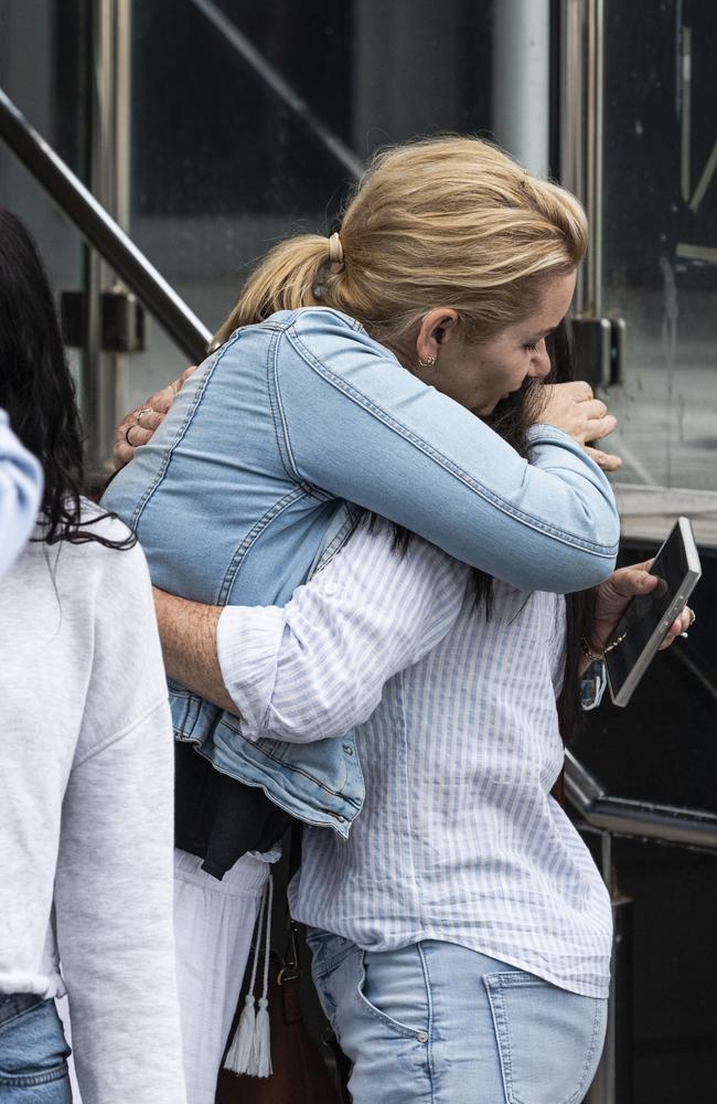 Mrs Gniel hugs family after Phillip Harris was found guilty of murdering her father.