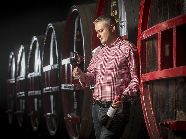 Penfolds global ambassador Jamie Sach with a bottle of St. Henri in the St. Henri Cellar at Penfolds Magill Estate.