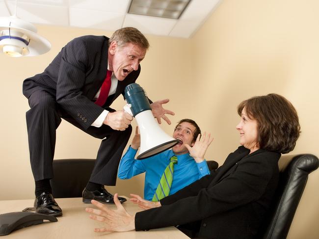 Crazy boss standing on conference table with megaphone yelling at shocked employees. property spruiker, aggressive salesman, generic