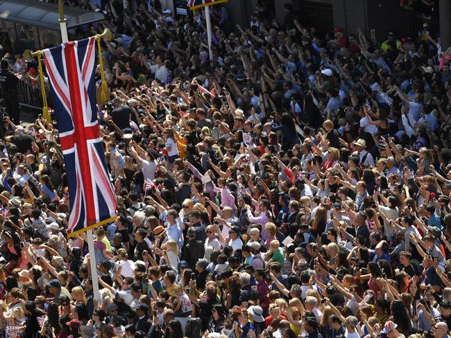 Fans cheer as Prince Harry, Duke of Sussex and the Duchess of Sussex ride a horse-drawn carriage after their wedding ceremony. Picture: Getty