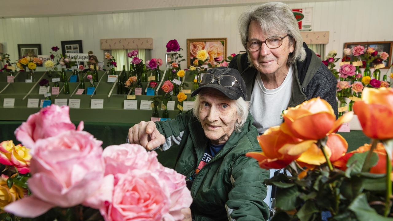 Wayne Leonard (left) and Don McKillop admire the entries of the 2022 Spring Champion Rose Show at the Rose Cottage in the Queensland State Rose Garden, Saturday, October 8, 2022. Picture: Kevin Farmer