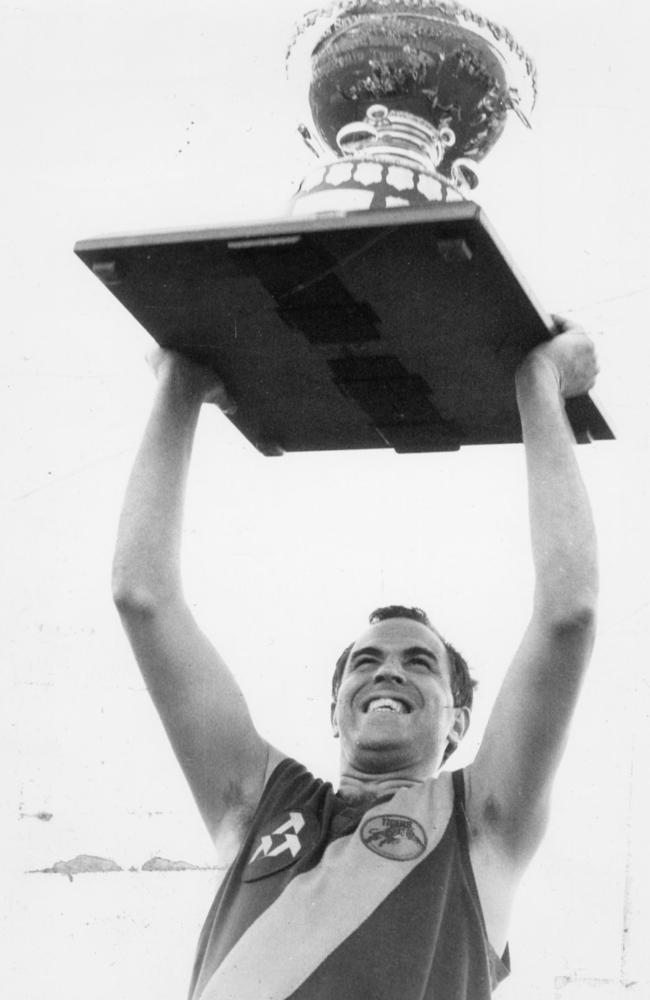 Peter Carey holds aloft the Thomas Seymour Hill trophy after Glenelg’s 1986 premiership win.