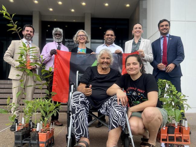 Territory MLAs Chansey Paech, Yingiya Mark Guyula, Justine Davis, Manuel Brown, Kat McNamara and Dheran Young (back row L-R), with Larrakia elder June Mills and activist Laniyuk. A petition will be tabled to parliament on Thursday 28, November 2024, calling for Lee Point to be returned to the Larrakia people. Picture: Fia Walsh.