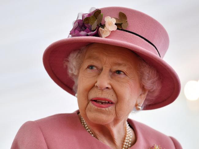 (FILES) In this file photo taken on October 15, 2020 Britain's Queen Elizabeth II speaks with staff during a visit to the Defence Science and Technology Laboratory (Dstl) at Porton Down science park near Salisbury, southern England. - Queen Elizabeth II is saddened by the challenges faced by her grandson Prince Harry and his wife Meghan, and takes their allegations of racism in the royal family seriously, Buckingham Palace said on March 9, 2021. "The whole family is saddened to learn the full extent of how challenging the last few years have been for Harry and Meghan. The issues raised, particularly that of race, are concerning," the palace said in a statement released on the queen's behalf. (Photo by Ben STANSALL / POOL / AFP)