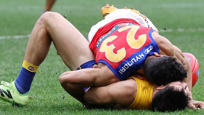 PERTH, AUSTRALIA - JULY 14: Liam Duggan of the Eagles lies concussed tackled by Charlie Cameron of the Lions during the 2024 AFL Round 18 match between the West Coast Eagles and the Brisbane Lions at Optus Stadium on July 14, 2024 in Perth, Australia. (Photo by Will Russell/AFL Photos via Getty Images)