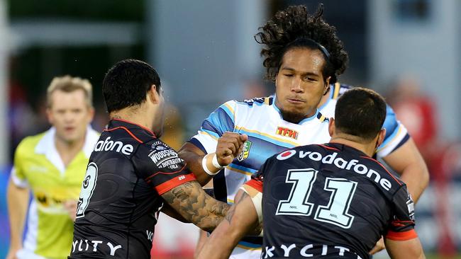 Agnatius Paasi of the Titans is tackled by Issac Luke (left) and Bodene Thompson.